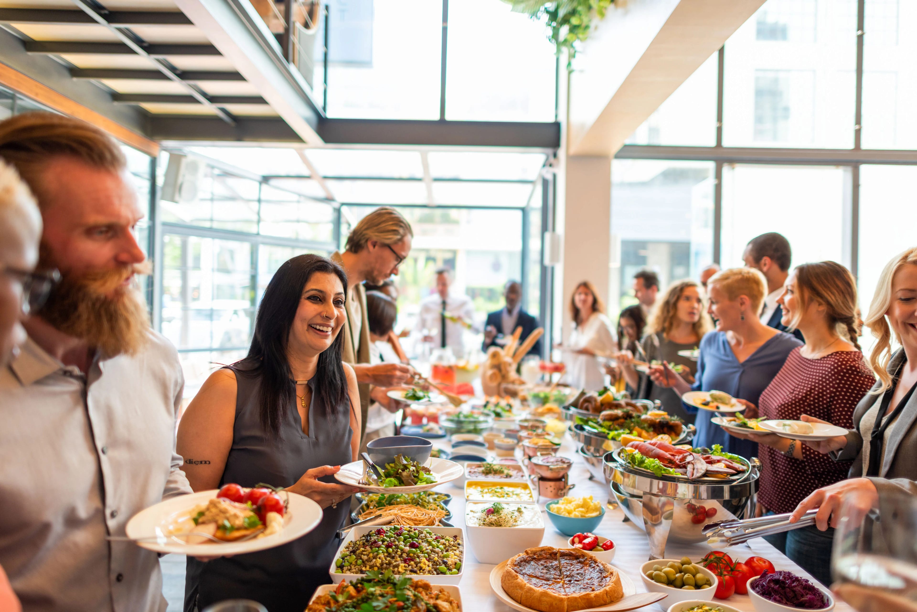 Guests serving themselves from a catered buffet spread at an event